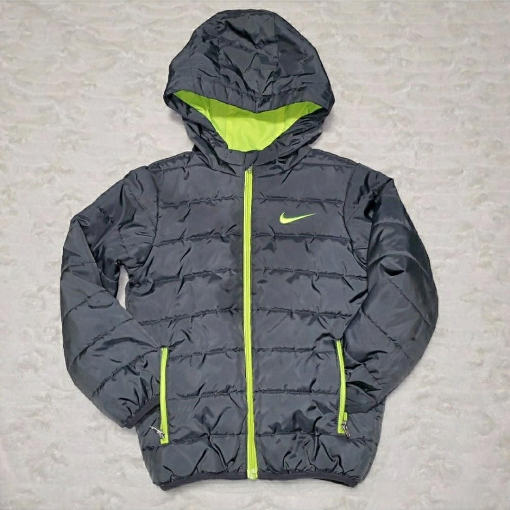 Nike kids navy puffer jacket with lime green accents.